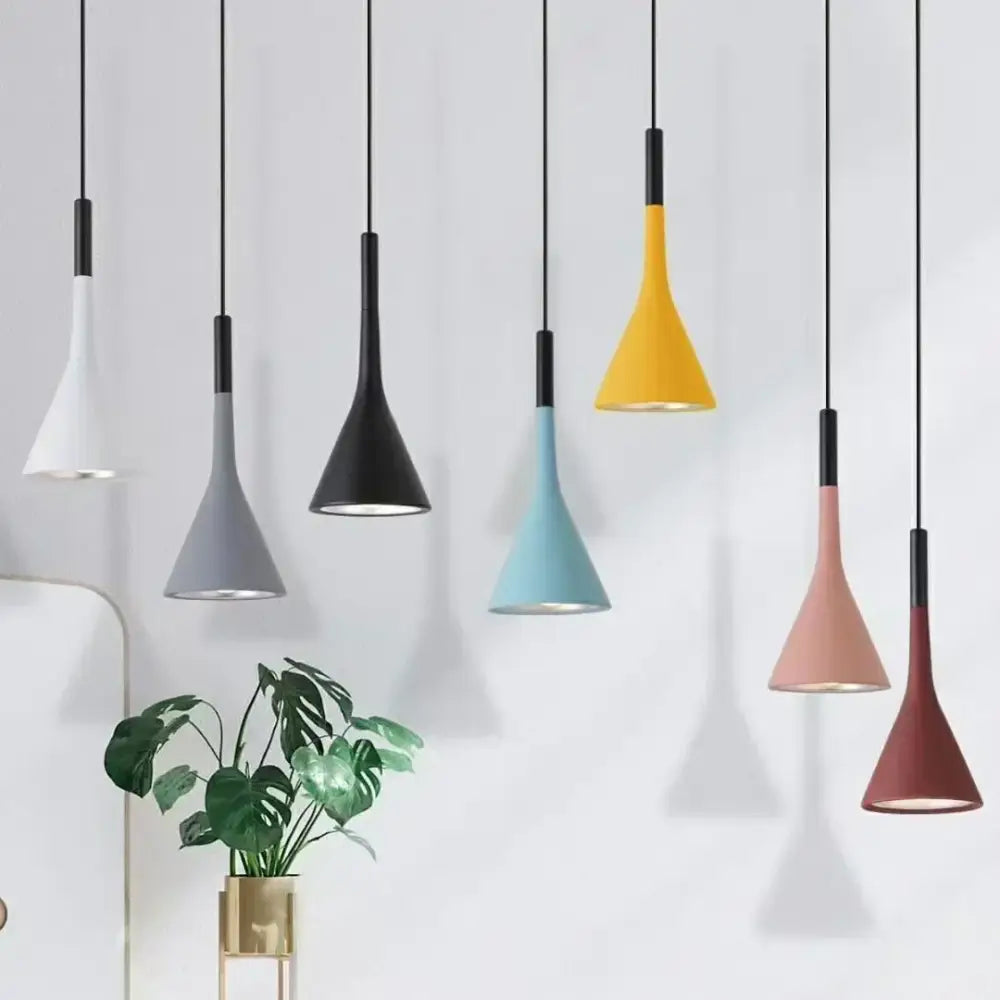 A modern minimalist multicolor metal pendant light set with matte finish and black cords for kitchen use