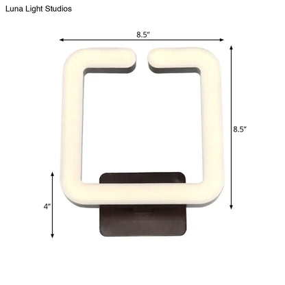 Cream-colored square led wall sconce with dark brown base providing warm white natural light for modern minimalist bedrooms