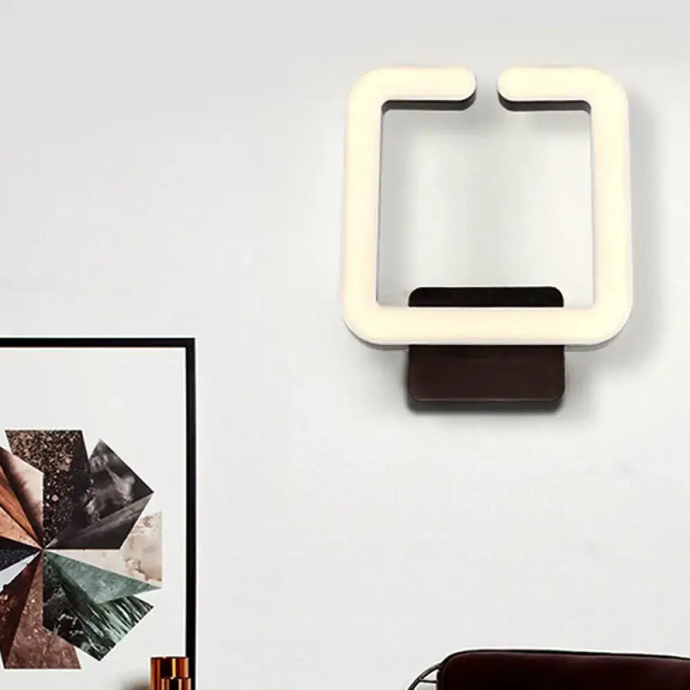 Modern minimalist off-white led wall sconce with dark brown base providing warm white natural light for bedroom use