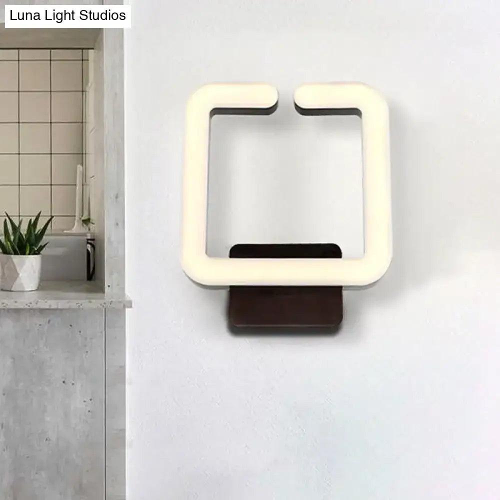 Modern off-white led wall sconce with dark brown base providing warm white natural light for minimalist bedrooms