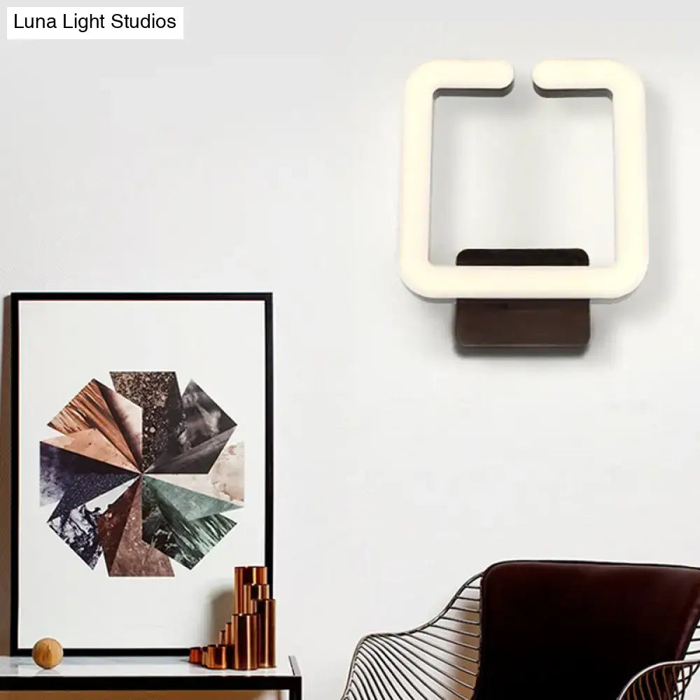 Modern minimalist off-white led wall sconce with sleek design and dark brown base providing warm white natural light