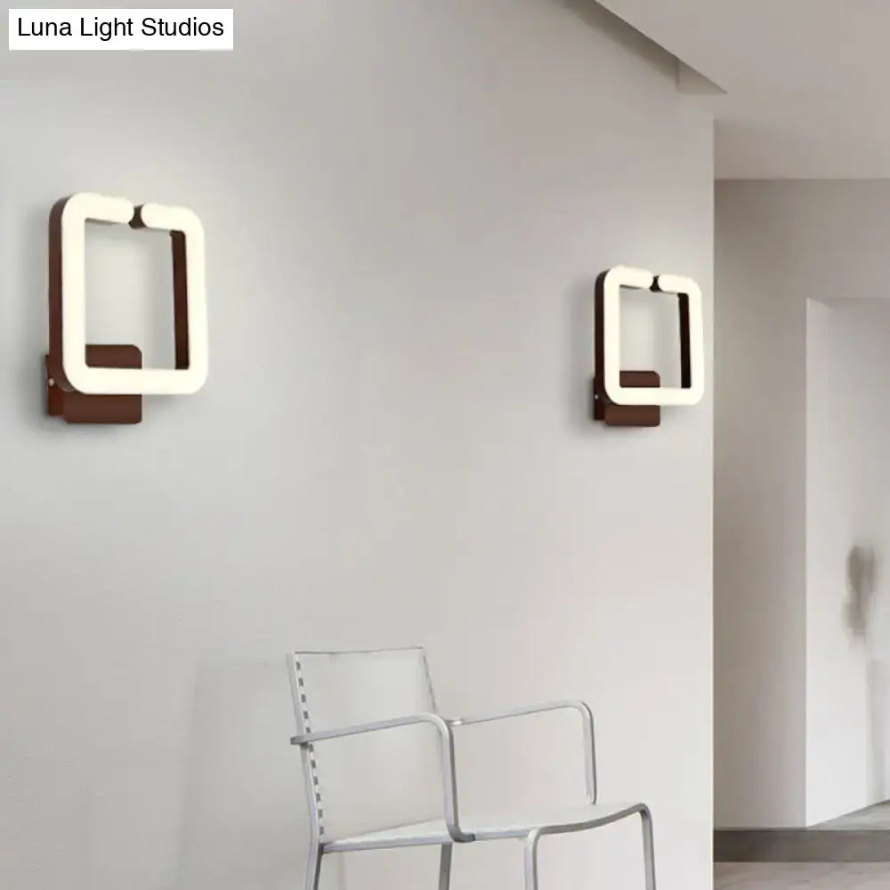 Modern minimalist off-white led wall sconce with warm white natural light and dark wood base for bedroom use