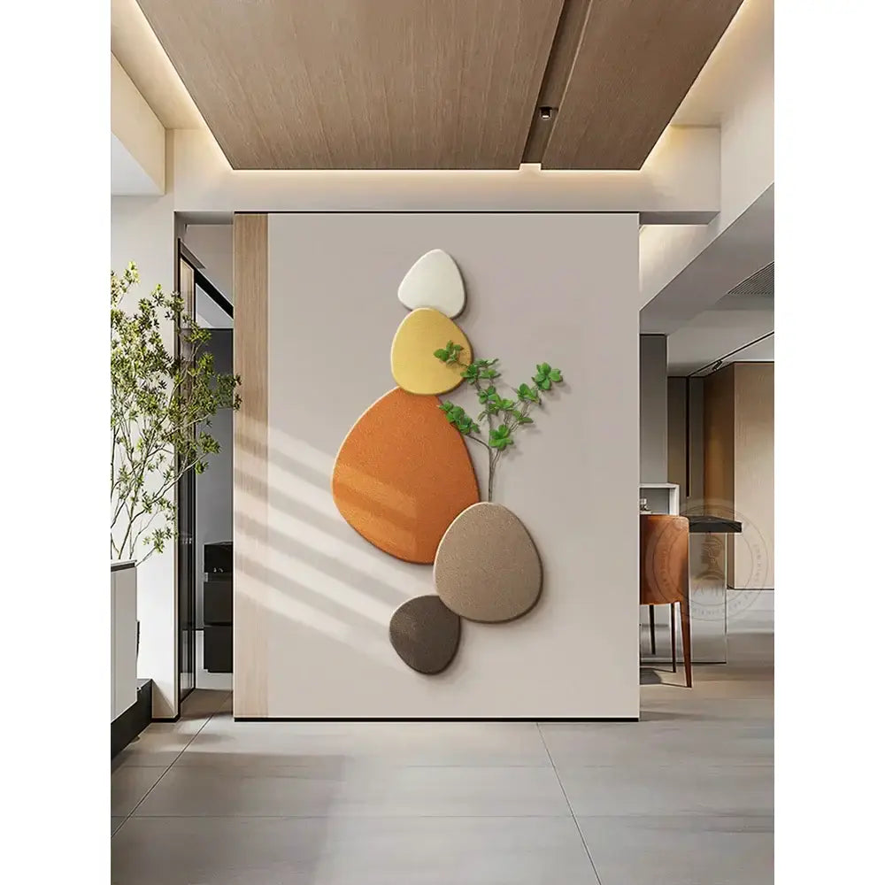 Modern abstract wall lamp with textured stone shapes in warm earth tones complements decorbites green plant mural