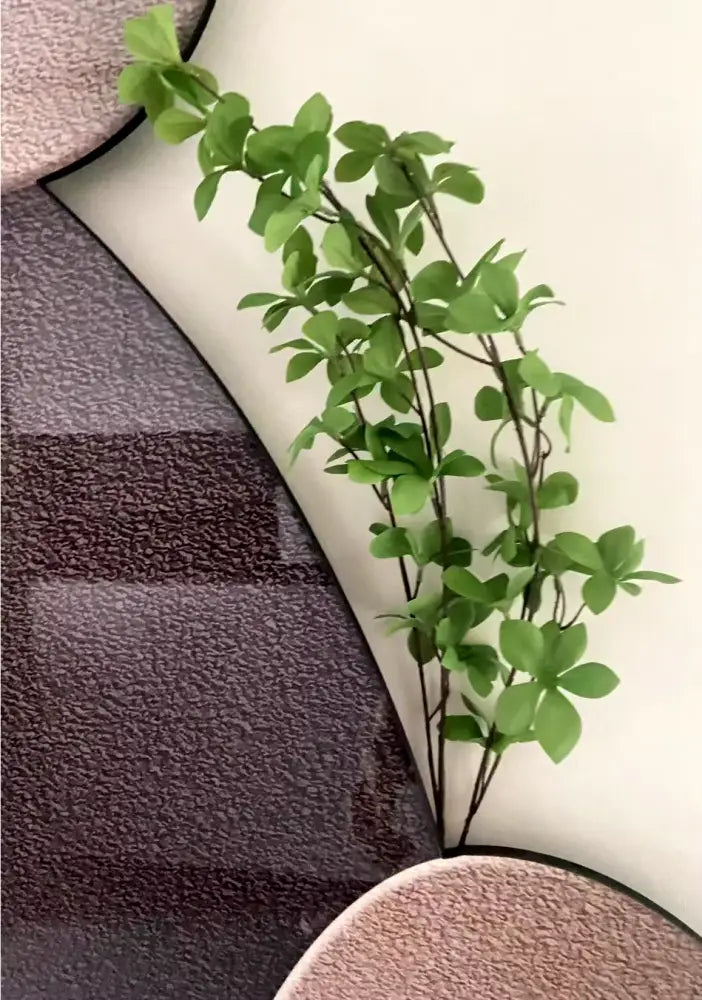 Modern minimalist textured stone wall lamp featuring a decorbites green plant mural with vibrant glossy leaves