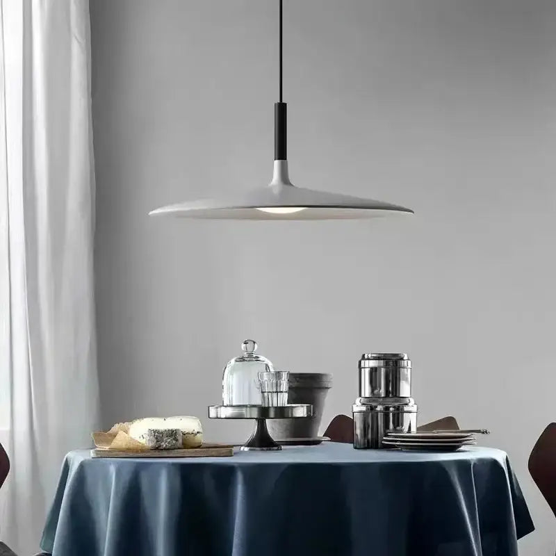 Modern minimalist ufo pendant lights with matte white flat disc shade and black accents for dining room led lighting