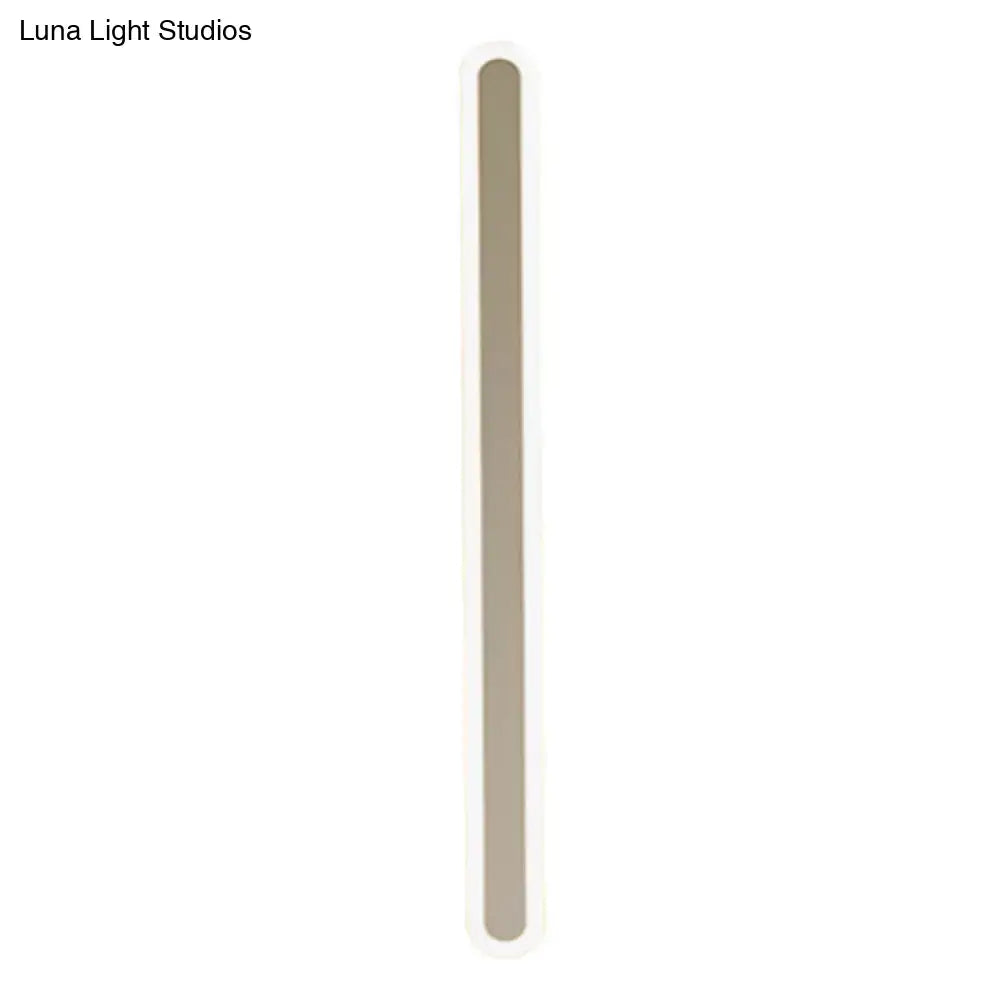 A sleek modern wall light with a minimalist slim beige rectangular body, perfect choice for bedroom light fixture
