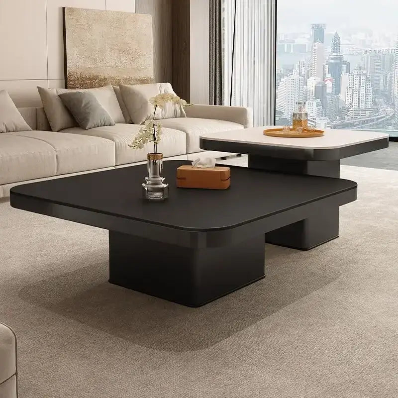 Modern minimalist white and black coffee table set featuring a sleek black coffee table with glossy finish for living room