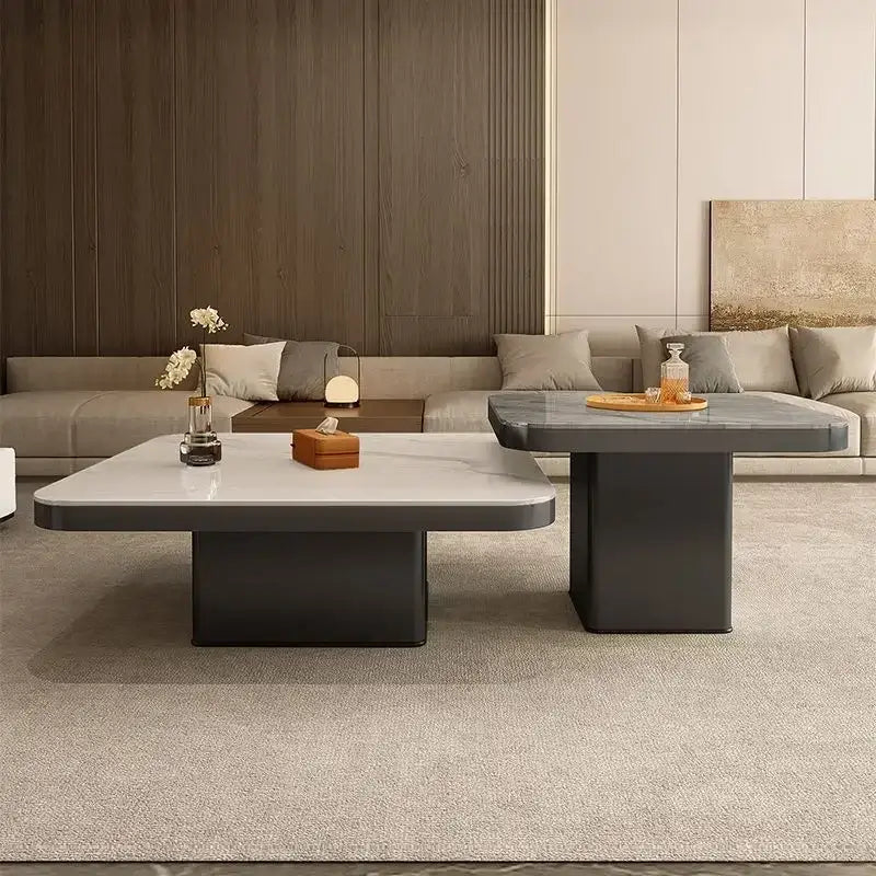 Modern minimalist coffee table set with a white marble top and dark gray base for elegant living room decor