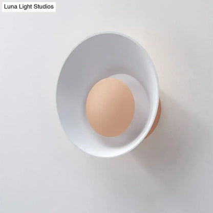 Minimalist white and black led wall lamp with warm circular light source mounted on white wall for living room use