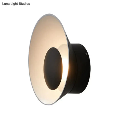 Modern minimalist black LED wall lamp with sleek circular design and warm ambient lighting for living room use