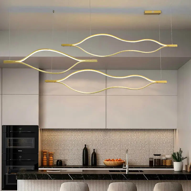 Modern minimalist white and bronze decorbites lip shaped chandelier with gold wave pendant lights above kitchen island