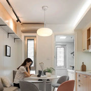 A modern white ceiling pendant lamp with sleek minimalist design for kitchen and bedroom lighting