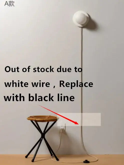 Modern minimalist white frosted glass ball wall light with spherical shade and metallic pole with visible power cord