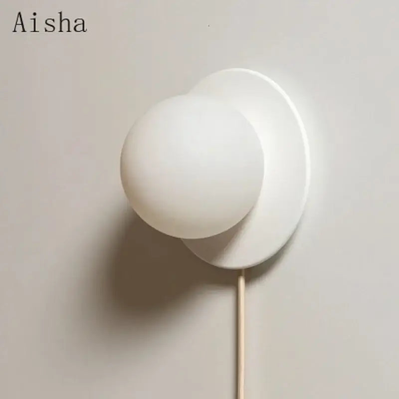 Modern minimalist white frosted glass ball wall light with matte finish and sleek design for bedroom sconce lighting