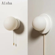 Modern minimalist white frosted glass ball wall light with spherical globe and circular base for bedroom wall light