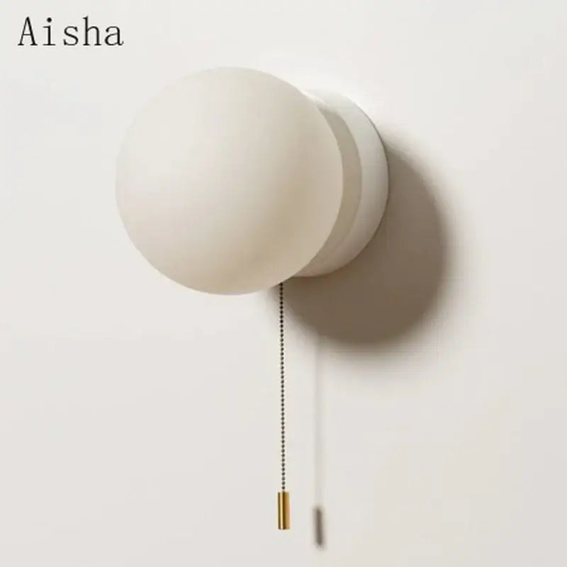 Aisha brand modern minimalist ball wall light with white frosted glass globe and brass pull chain for bedroom sconce