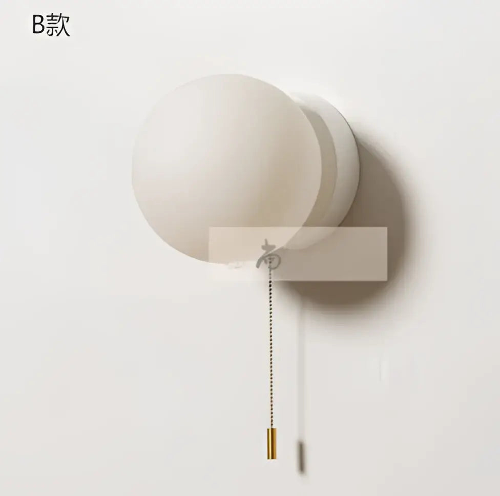 Modern minimalist white frosted glass ball wall light with brass pull chain for bedroom sconce lighting