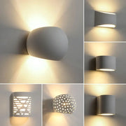 Modern minimalist white gypsum led wall lamp with sleek ceramic design and warm ambient lighting for bedroom use