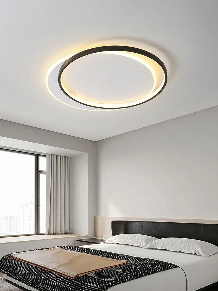 Modern minimalist white led ceiling lamp with black outer ring and warm white glow for bedroom ambient light decorbites led ceiling