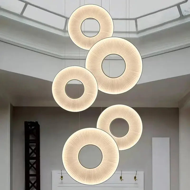 Modern minimalist white led pendant light with circular textured cream surfaces and warm glowing illumination for bedrooms