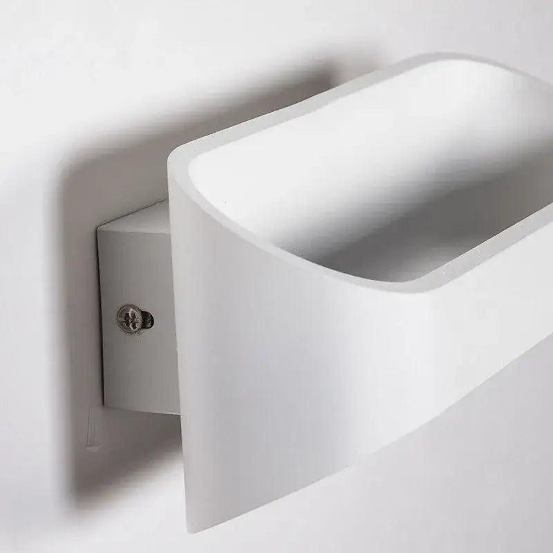 Modern minimalist white led wall lamps with sleek curved design and matte finish ideal for bedroom and living space lighting