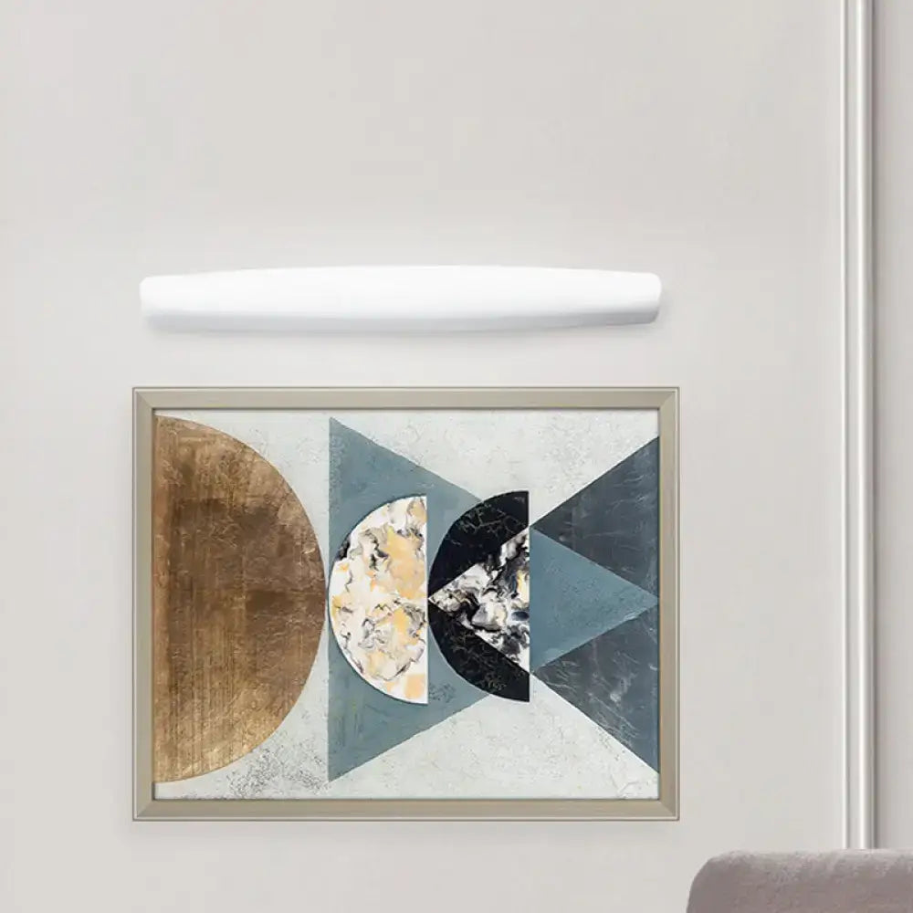 White rectangular wall light mounted above framed abstract artwork emitting warm white light for bedroom use