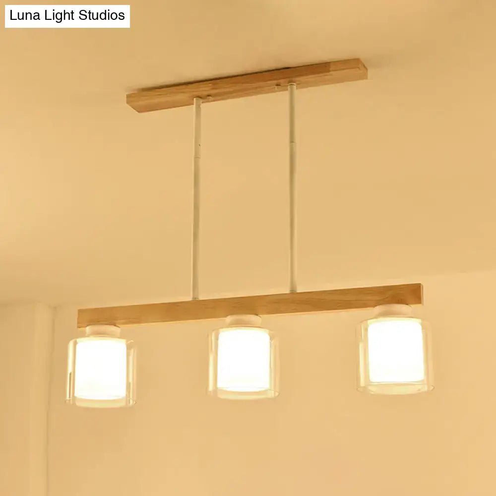 Minimalist wooden bar pendant light with three white glass cylindrical shades for modern dining room lighting