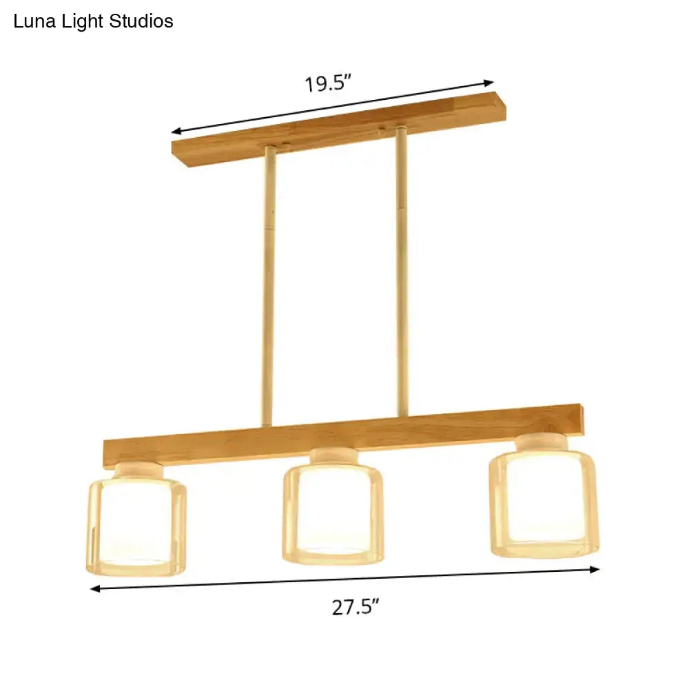Modern wooden chandelier with three white glass shades and brass accents for dining room lighting heads dining room