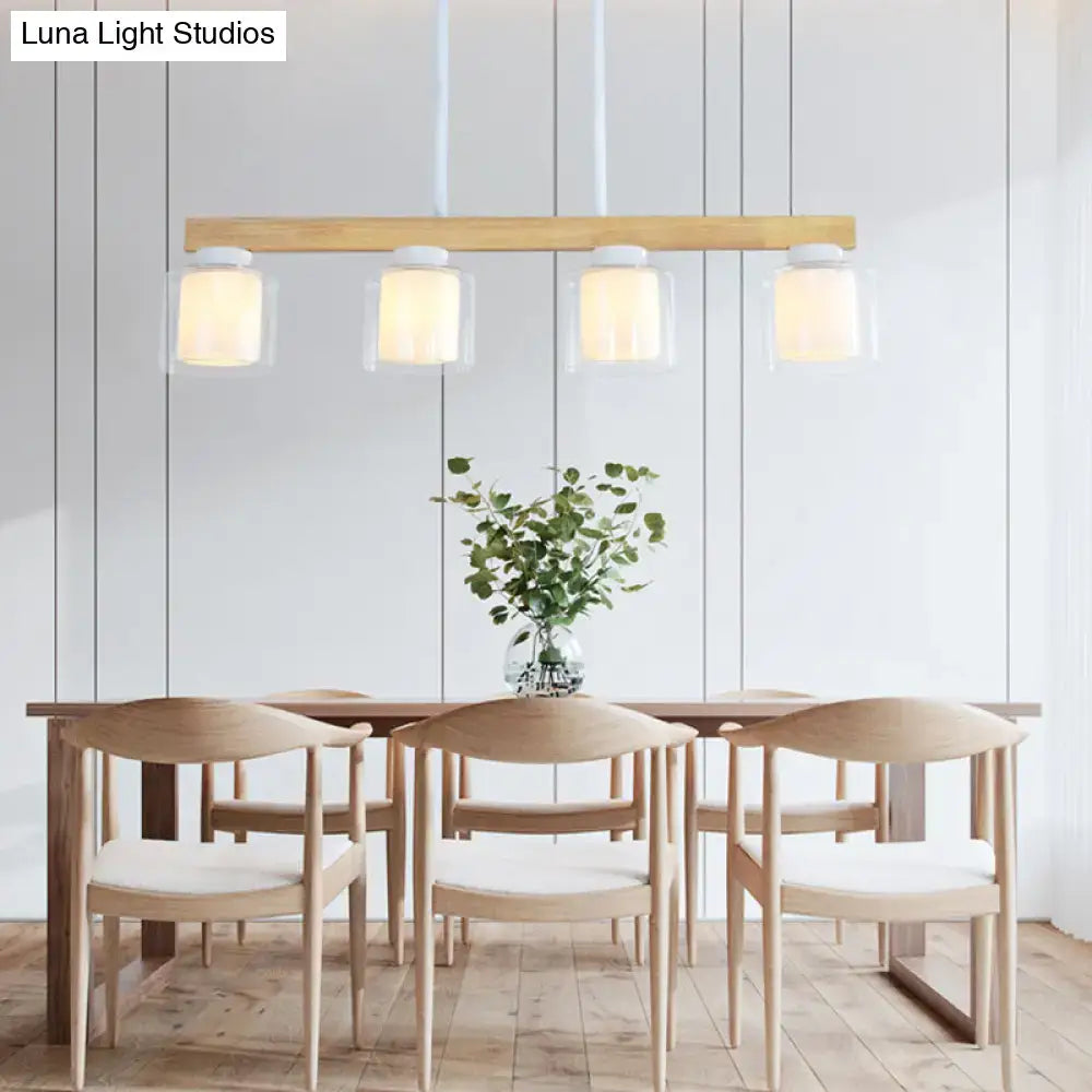 Modern minimalist wood and white glass pendant light with four heads for warm diffused dining room lighting