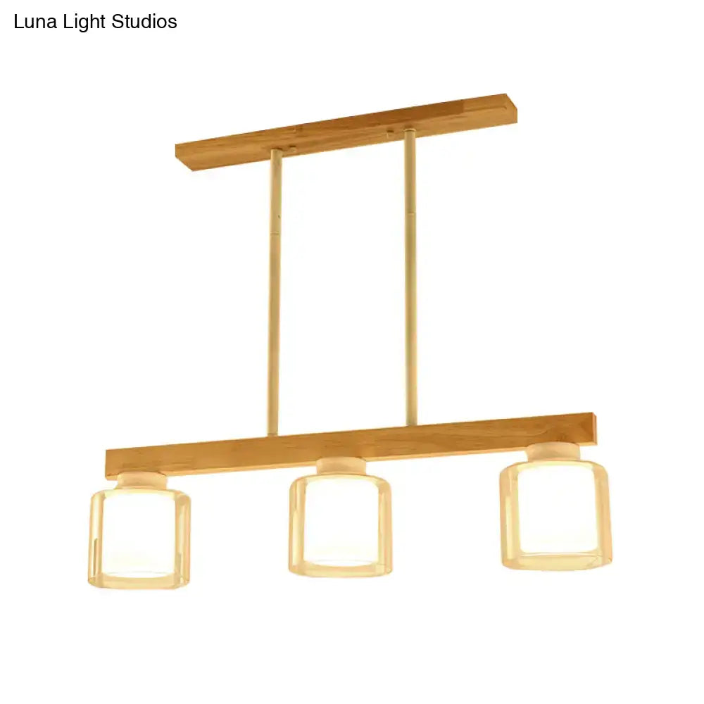 Modern minimalist wood and white glass pendant light with warm wooden frame and three square heads for dining room