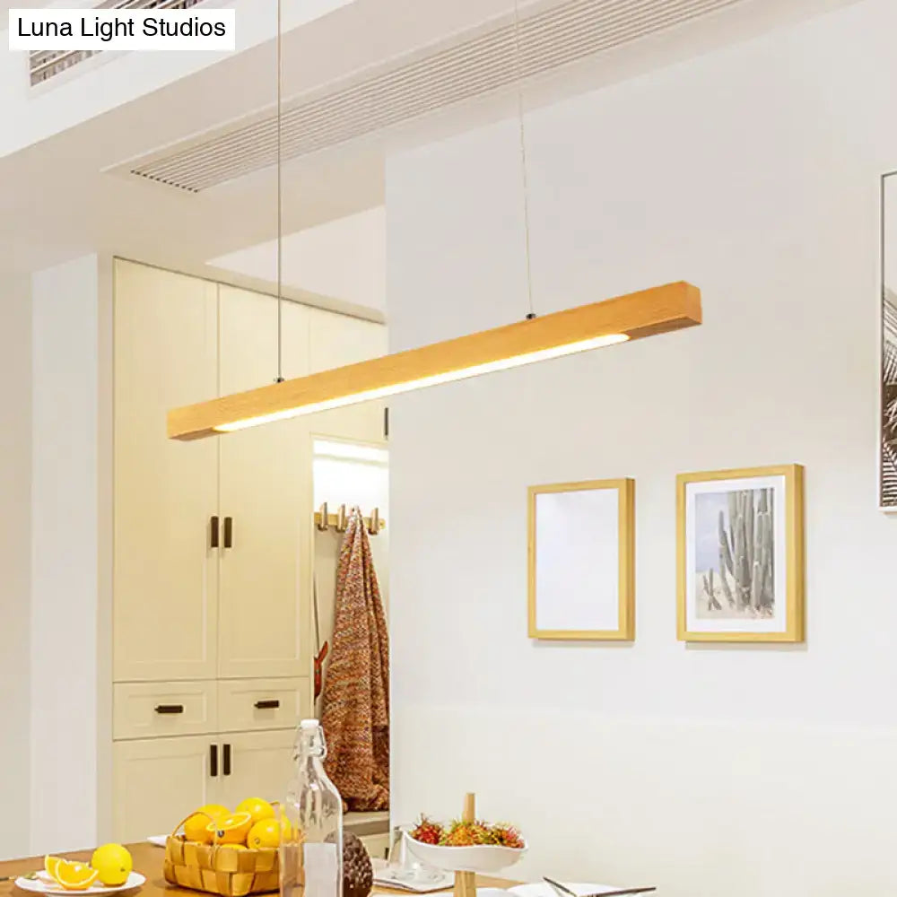 Modern minimalist wood linear island pendant light with sleek wooden frame and warm led strip ambient glow