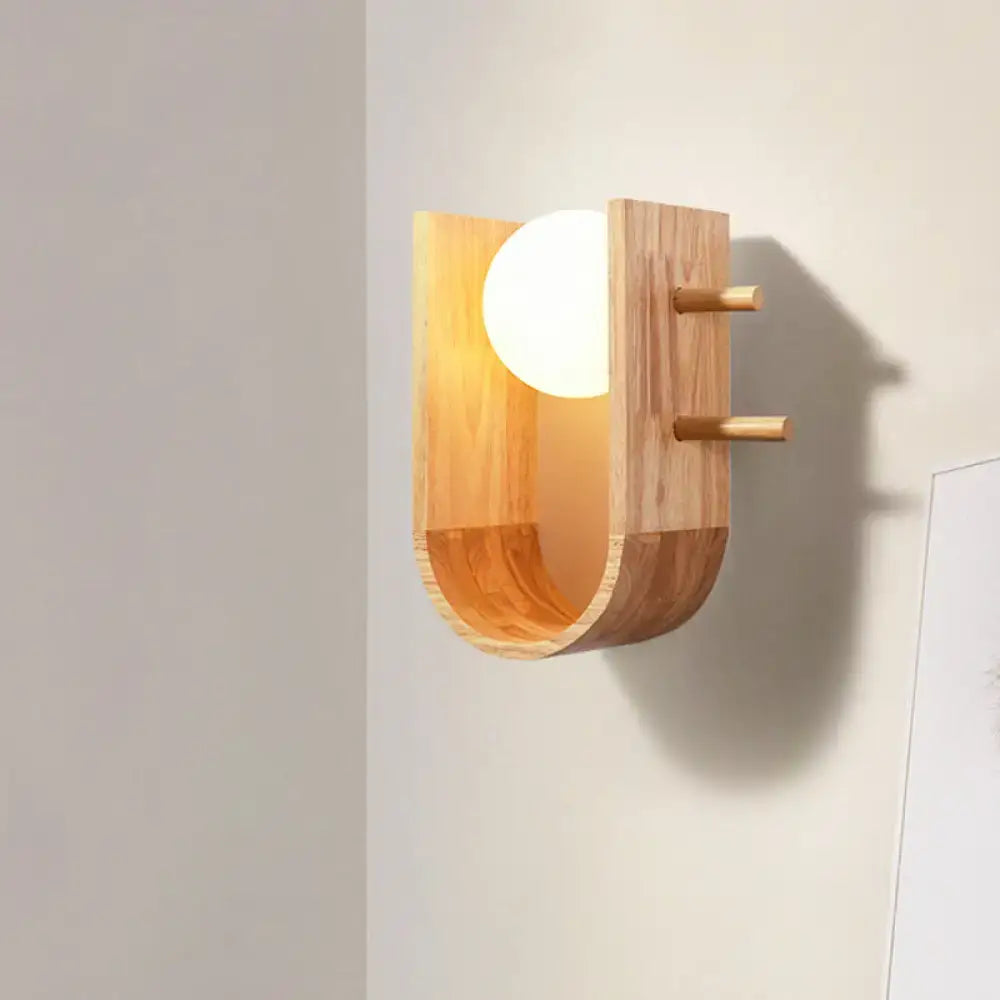 Modern minimalist wooden sconce light with warm glow and two small pegs for hanging as wall light in bedroom