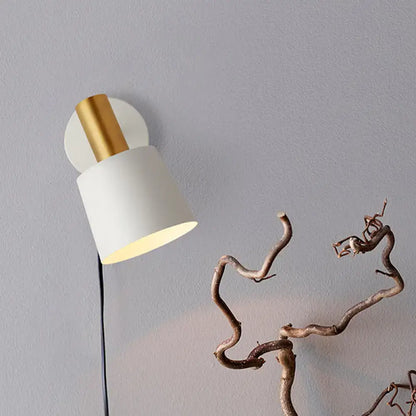 Modern mint green and gold metal drum sconce wall mounted lamp with a matte white cylindrical shade and polished gold base