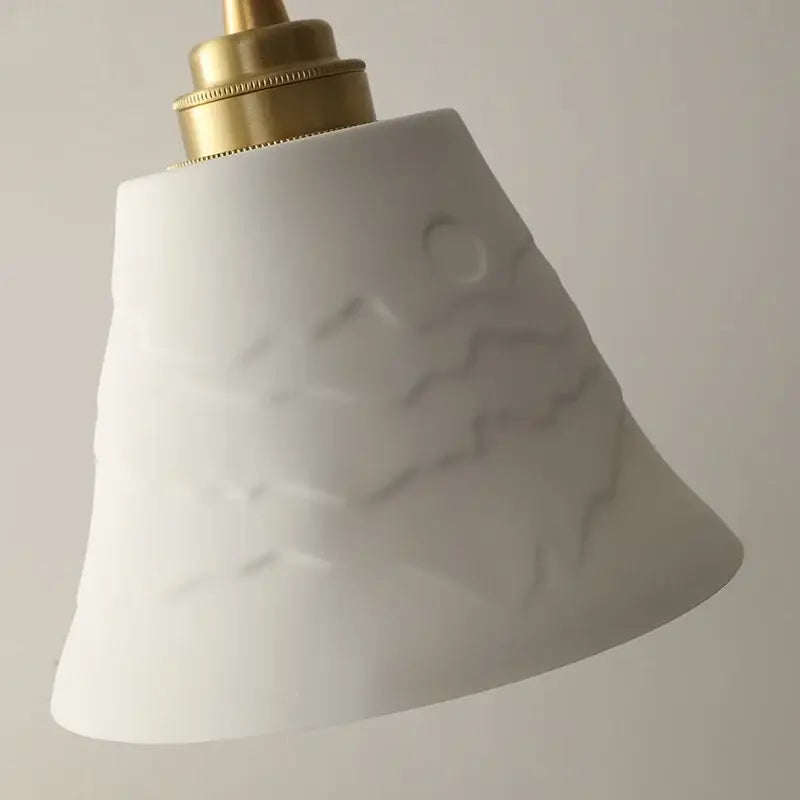 Modern moon ceramic led pendant lamp with white ceramic lampshade embossed with waves and brass-finished top decorbites ceramic led