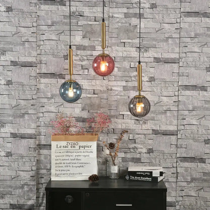 Modern multi color glass pendant light with painted iron finish featuring pink blue and smoky gray shades for dining room