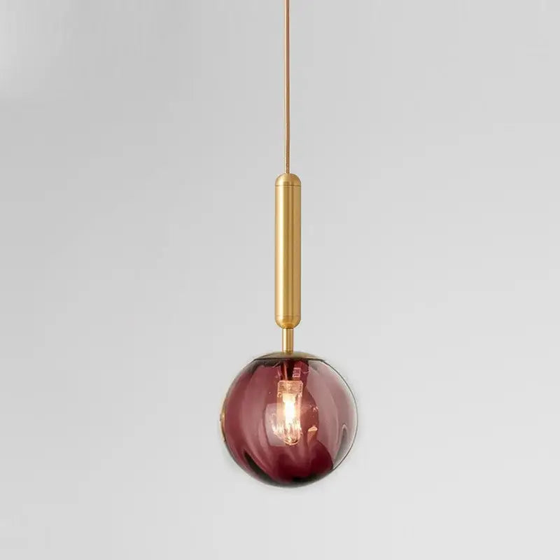A sleek spherical glass pendant light with a deep burgundy globe and painted iron finish for dining rooms