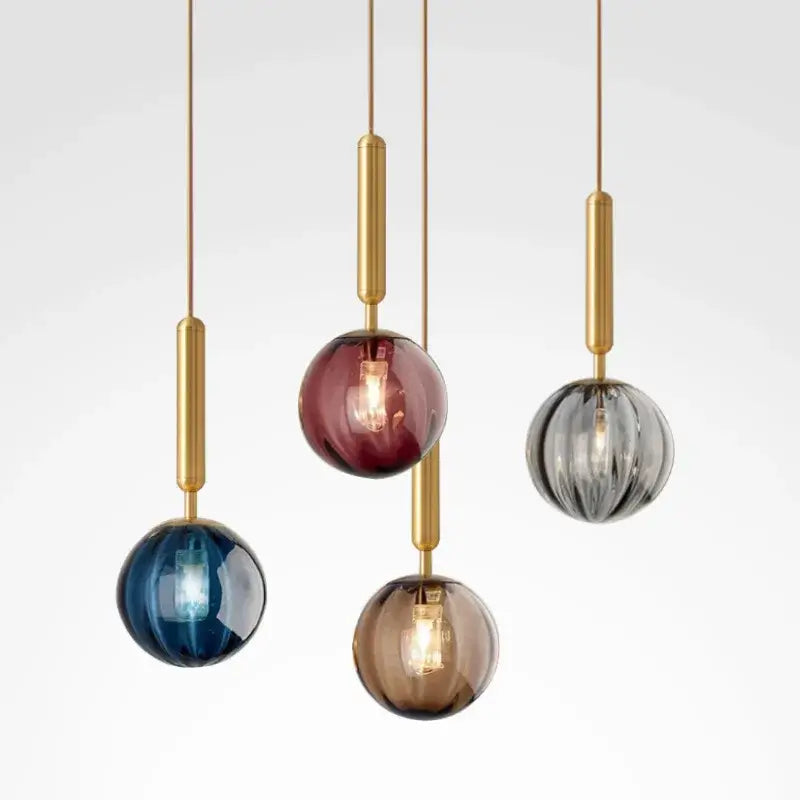 Modern multi color glass pendant light with painted iron finish featuring five brass rods and blue, burgundy, gray, amber, clear globes