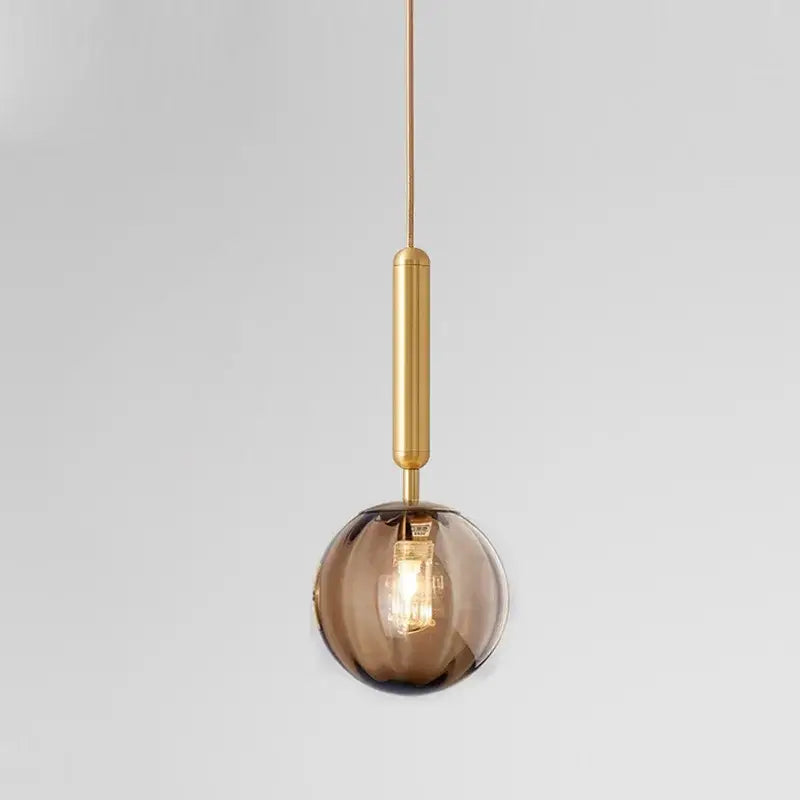 Modern multi color glass pendant light featuring a spherical amber glass pendant light with painted iron finish