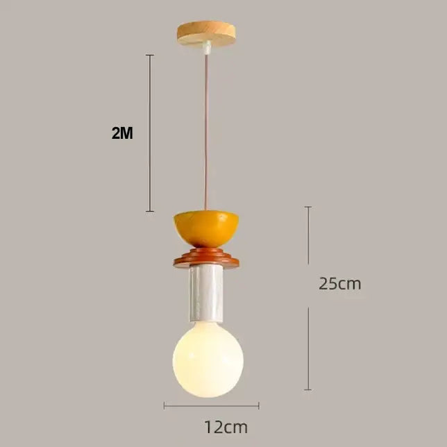 Modern pendant light with warm yellow ceramic bowl, wooden accents, white stem, and iron accent cord pendant for kitchen dining