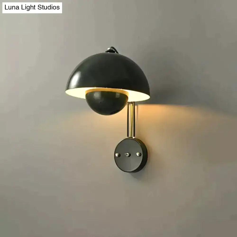 Black matte wall lamp with brass base type and dome-shaped shade in modern mushroom design for bedroom use