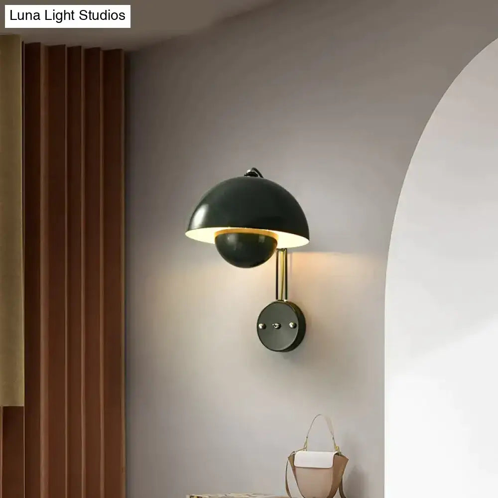 Modern mushroom wall lamp with black matte finish, brass base type, and gold-toned stem featuring a warm dome shade