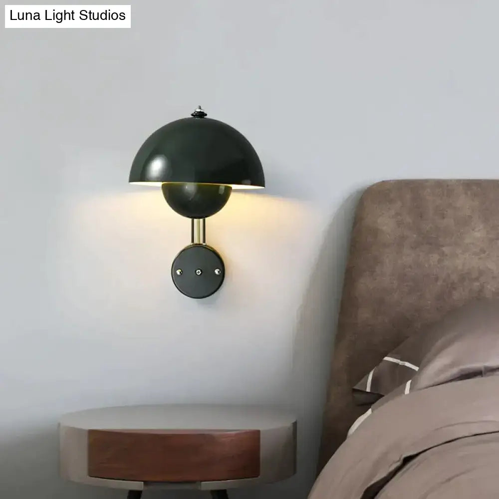 Black dome-shaped modern mushroom wall lamp with brass base type and circular accent for bedroom use