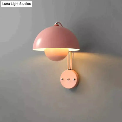 Pastel pink metallic modern mushroom wall lamp with brass base type and dome-shaped shade for bedroom lighting