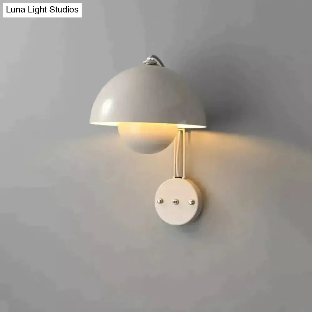 A sleek white ceramic modern mushroom wall lamp with dome shade and brass base type finish for bedroom use