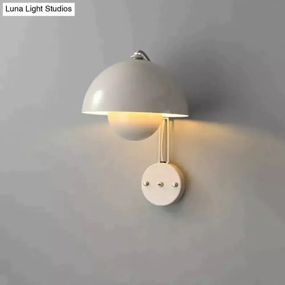 A sleek white ceramic modern mushroom wall lamp with dome shade and brass base type finish for bedroom use