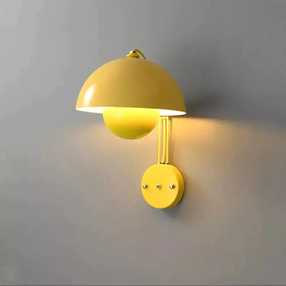 Modern mushroom wall lamp with vibrant yellow dome-shaped shade and brass base type for stylish bedroom lighting
