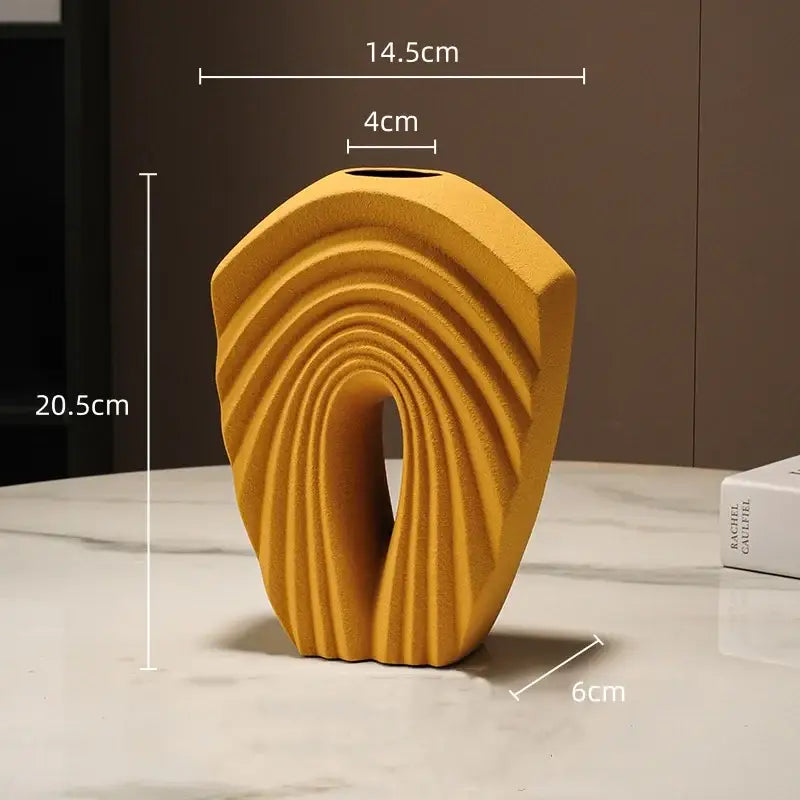 A modern mustard yellow ceramic vase with geometric folds and sculpted ribbed design for living room decorbites decor