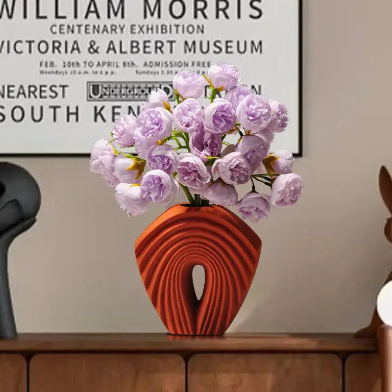 A vibrant orange geometric folds ceramic vase with concentric ridges and open center for modern living room decorbites decor