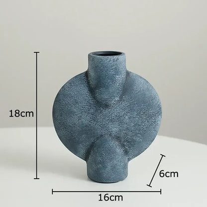 Matte blue ceramic disc vase with textured asymmetrical design and rounded contours for modern decorbites ceramic decor