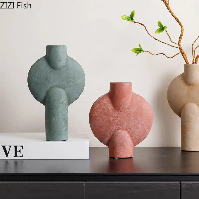 Three modern decorbites ceramic disc vases in muted green terracotta and beige with abstract organic shapes for living room decor
